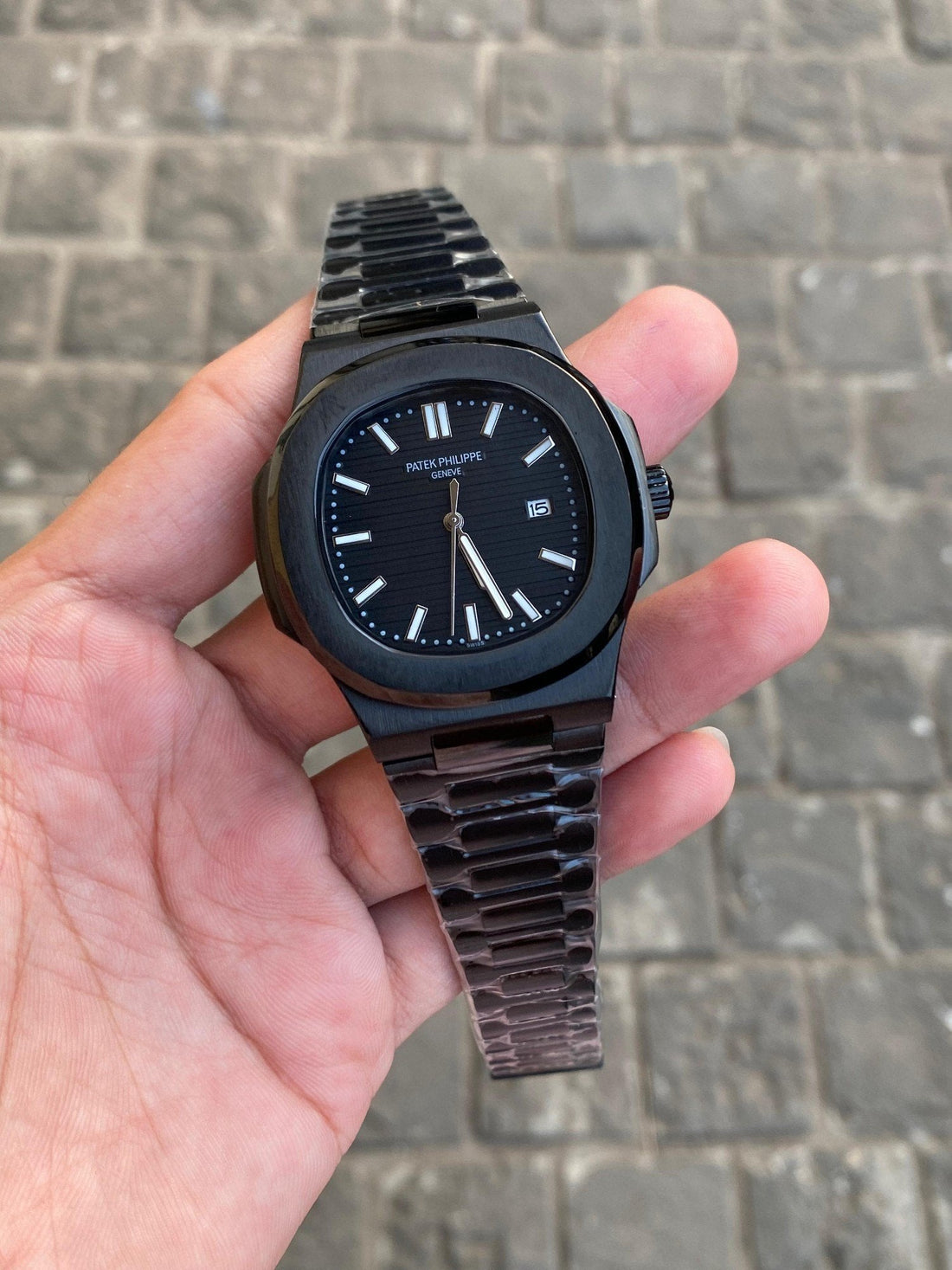 Nautilus watch with a black dial and a black band.
